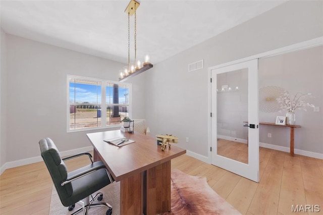 office area with light wood-style floors, french doors, and baseboards