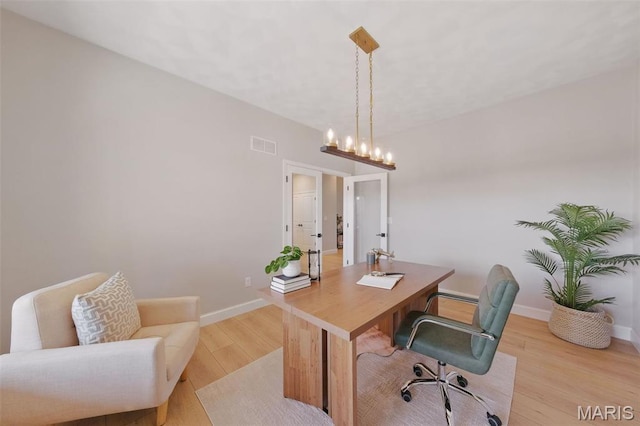 home office featuring light wood-type flooring, a chandelier, baseboards, and french doors