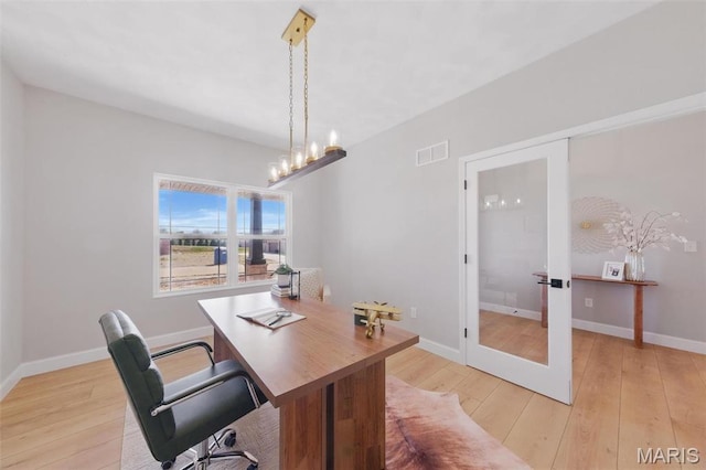 home office with french doors, light wood-style flooring, a chandelier, and baseboards