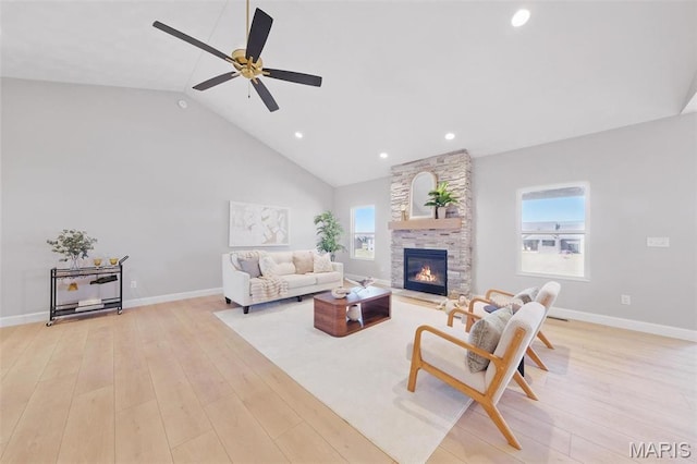 living area featuring light wood-type flooring, ceiling fan, a fireplace, high vaulted ceiling, and recessed lighting
