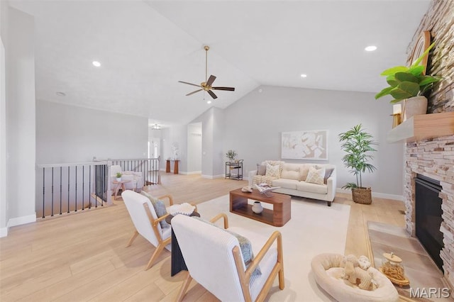 living room featuring wood finished floors, ceiling fan, vaulted ceiling, a fireplace, and recessed lighting