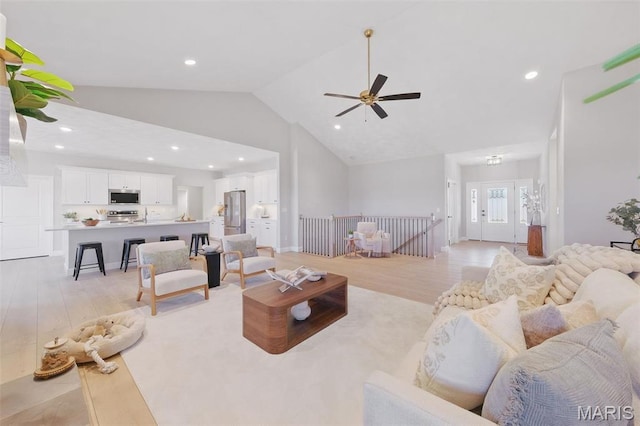 living area featuring light wood-style floors, recessed lighting, a ceiling fan, high vaulted ceiling, and french doors