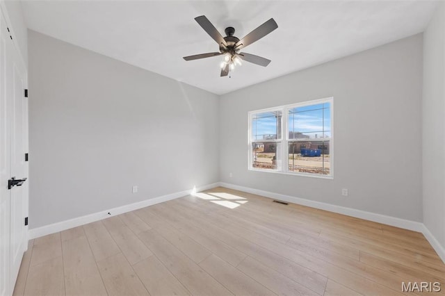 unfurnished room with baseboards, light wood-type flooring, and a ceiling fan