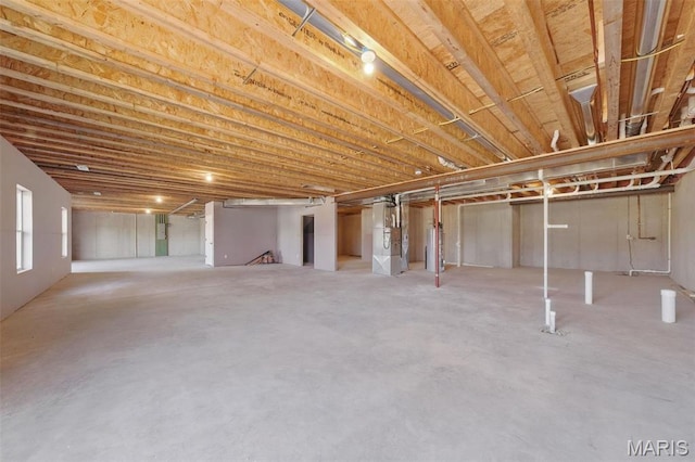 basement with water heater and heating unit