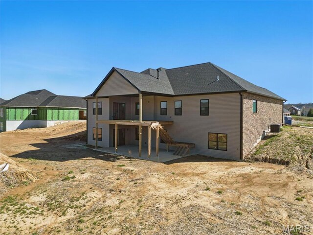 rear view of property with stairway, central air condition unit, a patio, and a wooden deck