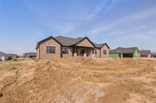 craftsman-style home with brick siding