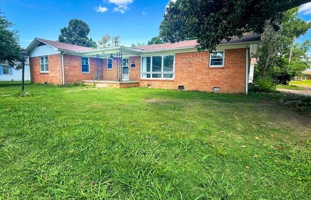 single story home with crawl space, brick siding, and a front lawn