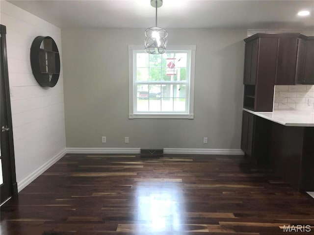 1202 S Gertrude St, Salem, MO 65560 - unfurnished dining area featuring dark wood-style flooring and baseboards