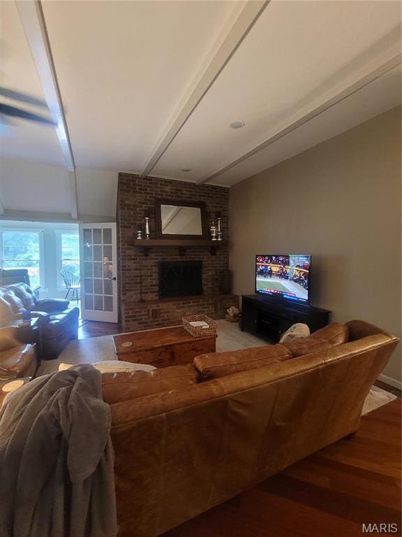 16225 Shady Ln, Dexter, MO 63841 - living area with a brick fireplace, wood finished floors, and beamed ceiling