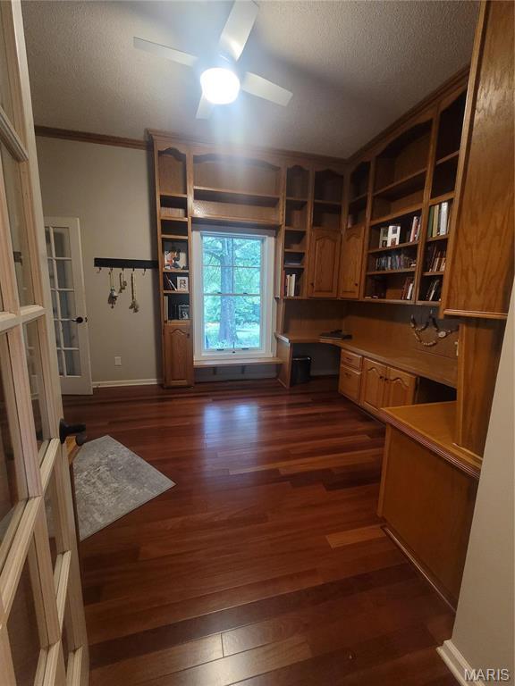 16225 Shady Ln, Dexter, MO 63841 - unfurnished office with built in study area, a textured ceiling, dark wood-type flooring, ornamental molding, and ceiling fan