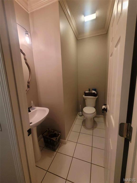 16225 Shady Ln, Dexter, MO 63841 - bathroom with crown molding, tile patterned flooring, toilet, and baseboards