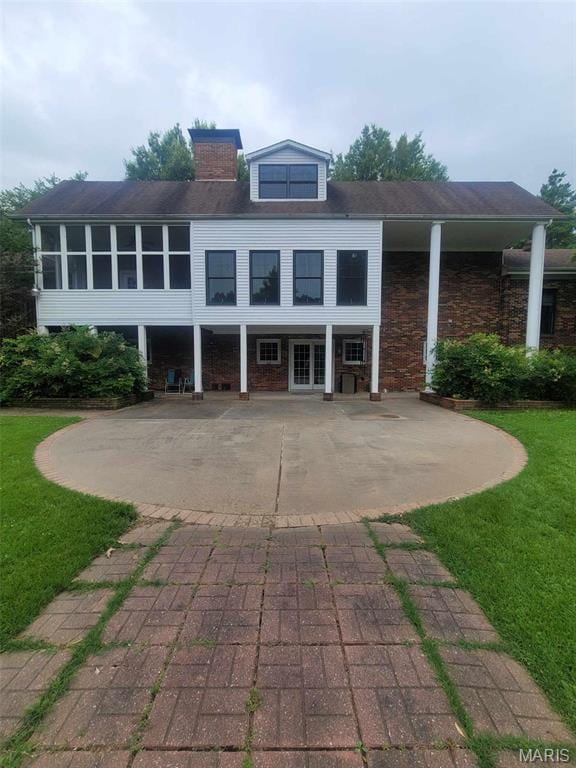 16225 Shady Ln, Dexter, MO 63841 - back of property featuring a lawn, a chimney, and french doors