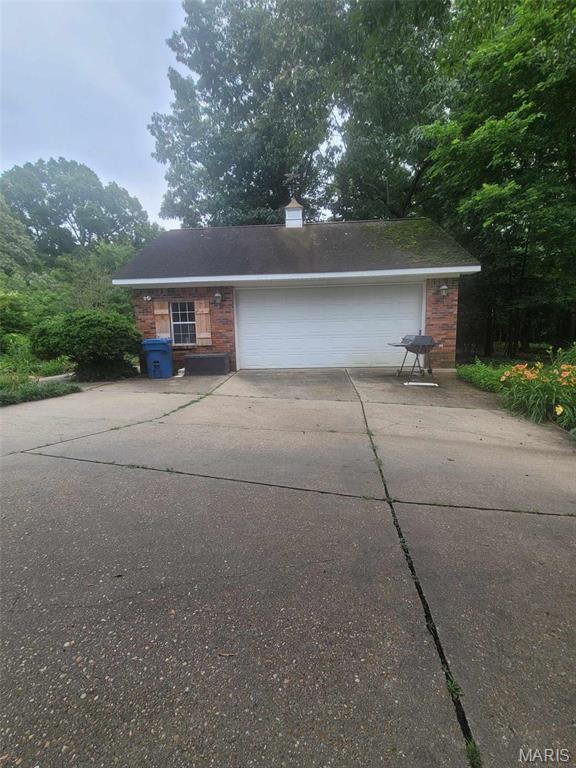 16225 Shady Ln, Dexter, MO 63841 - view of front of property featuring a garage, driveway, and brick siding