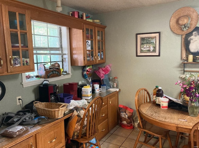 131 W Outer Rd, Poplar Bluff, MO 63901 - kitchen with brown cabinetry, glass insert cabinets, and light tile patterned floors