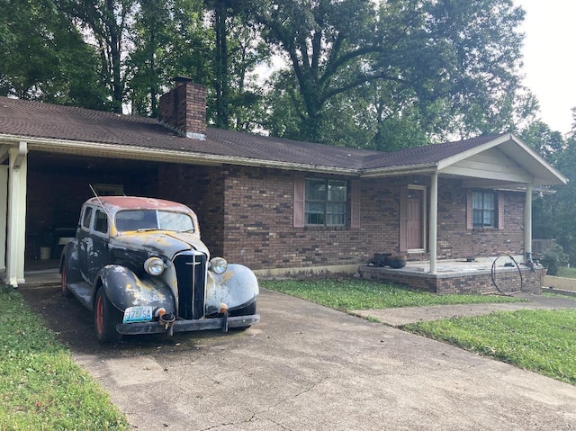 131 W Outer Rd, Poplar Bluff, MO 63901 - ranch-style house featuring a chimney, brick siding, and a porch
