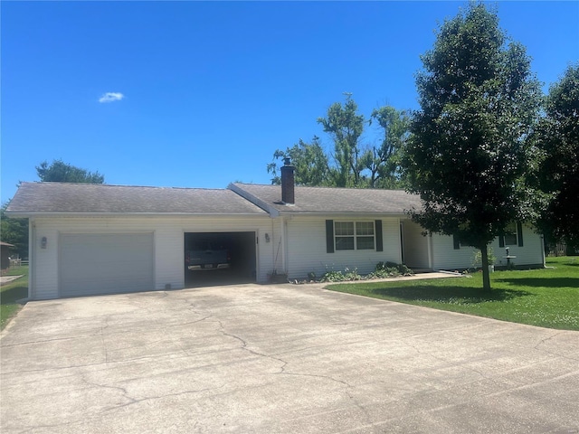 ranch-style home with a garage, driveway, a front lawn, and a chimney