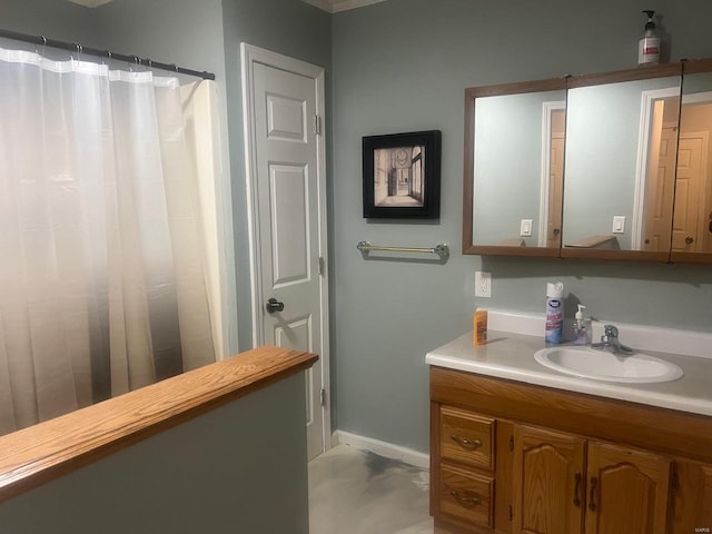 full bathroom with vanity, baseboards, and curtained shower