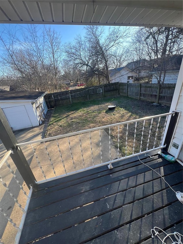 wooden terrace featuring a fenced backyard