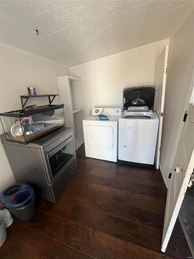 washroom with washer and clothes dryer, dark wood-type flooring, and ornamental molding