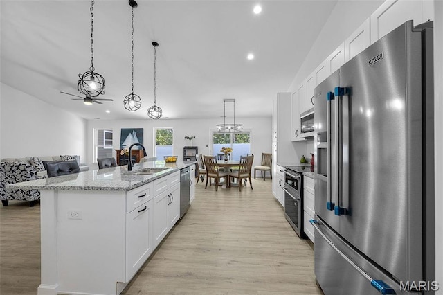 1523 Hickory Lndg, De Soto, MO 63020 - kitchen with appliances with stainless steel finishes, a sink, white cabinets, light wood-type flooring, and recessed lighting