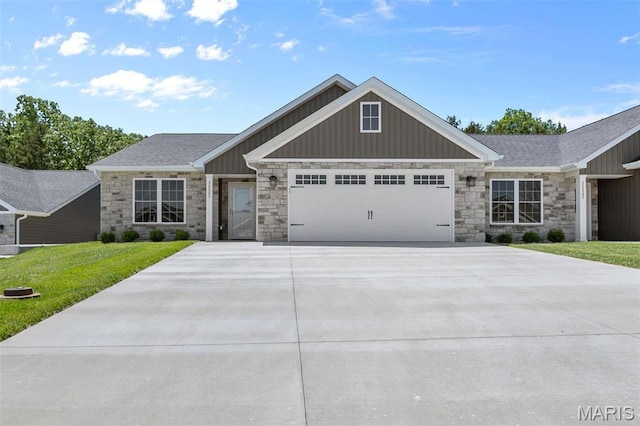 1523 Hickory Lndg, De Soto, MO 63020 - view of front facade featuring stone siding, board and batten siding, an attached garage, and driveway