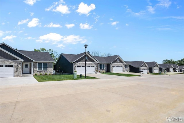 1523 Hickory Lndg, De Soto, MO 63020 - view of front of home with stone siding, a residential view, concrete driveway, an attached garage, and board and batten siding