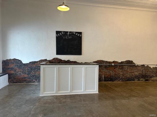 13 N Division St, Duquoin, IL 62832 - detailed view of finished concrete floors, ornamental molding, and brick wall