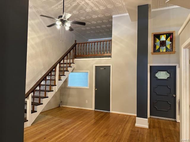 13 N Division St, Duquoin, IL 62832 - unfurnished living room with ceiling fan, hardwood / wood-style floors, stairway, baseboards, and an ornate ceiling