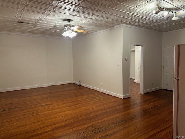 13 N Division St, Duquoin, IL 62832 - spare room with a ceiling fan, an ornate ceiling, wood finished floors, crown molding, and baseboards