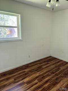507 S Railroad, Matthews, MO 63867 - spare room featuring dark wood-style flooring, baseboards, and a ceiling fan