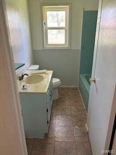 507 S Railroad, Matthews, MO 63867 - bathroom with toilet, vanity, brick patterned flooring, and a bath