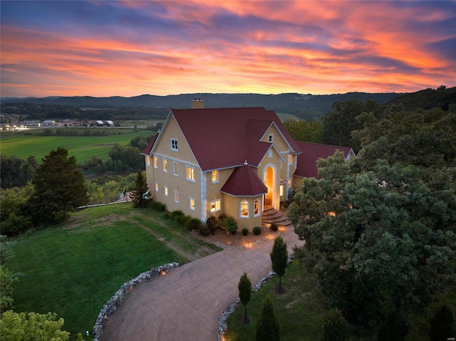 aerial view of property and surrounding area featuring mountains