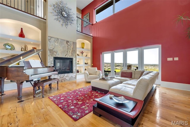 265 Deer Run Ln, Eureka, MO 63025 - living room with a towering ceiling, plenty of natural light, hardwood / wood-style flooring, and a high end fireplace