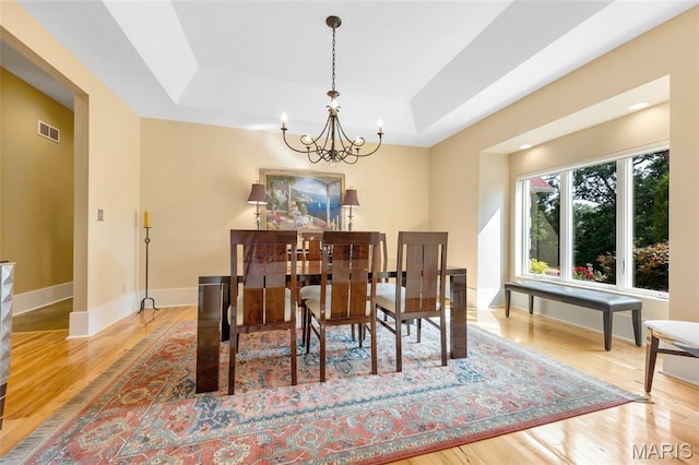 265 Deer Run Ln, Eureka, MO 63025 - dining room featuring a raised ceiling, a chandelier, wood finished floors, and baseboards