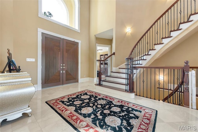 265 Deer Run Ln, Eureka, MO 63025 - foyer with a towering ceiling, marble finish flooring, stairway, baseboards, and french doors