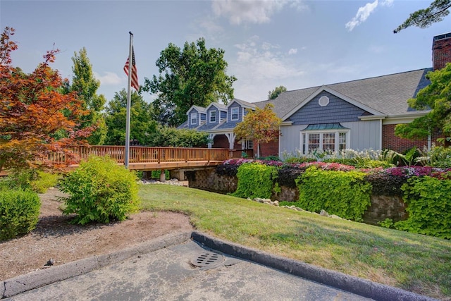 view of grassy yard featuring a wooden deck
