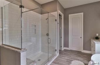 2626 Center Ave, Wildwood, MO 63040 - full bathroom with a stall shower, baseboards, and wood finished floors