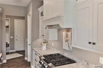 2626 Center Ave, Wildwood, MO 63040 - kitchen with stove, white cabinets, dark wood finished floors, and light stone counters
