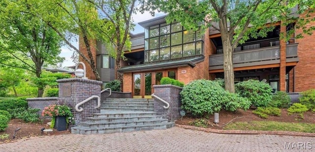 155 N Hanley Rd Unit 305, Saint Louis, MO 63105 - view of front of home featuring brick siding and french doors