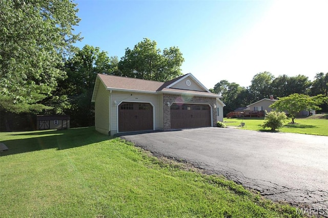 1710 Doe Run Dr, Vandalia, IL 62471 - view of front of property with an attached garage, driveway, a front lawn, and a storage unit
