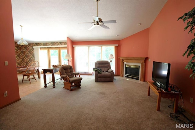 1710 Doe Run Dr, Vandalia, IL 62471 - carpeted living area featuring a ceiling fan, a fireplace, and lofted ceiling