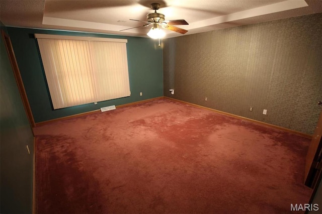 1710 Doe Run Dr, Vandalia, IL 62471 - carpeted empty room with ceiling fan and a raised ceiling