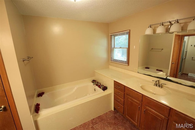 1710 Doe Run Dr, Vandalia, IL 62471 - full bathroom featuring a whirlpool tub, vanity, and a textured ceiling