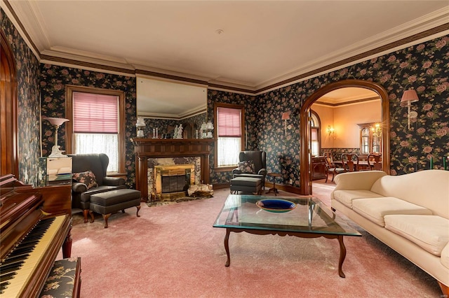 202 Poplar St, Harrisburg, IL 62946 - carpeted living area featuring wallpapered walls, ornamental molding, arched walkways, and a premium fireplace