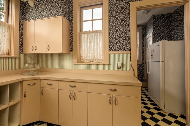 202 Poplar St, Harrisburg, IL 62946 - kitchen featuring freestanding refrigerator, wallpapered walls, light flooring, and light countertops