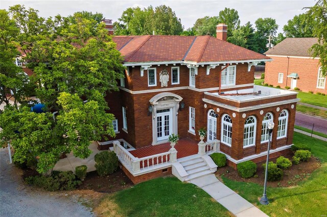 202 Poplar St, Harrisburg, IL 62946 - view of front facade with a chimney, brick siding, french doors, and a front yard
