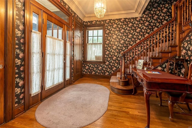 202 Poplar St, Harrisburg, IL 62946 - foyer featuring wallpapered walls, wood finished floors, crown molding, stairway, and baseboards