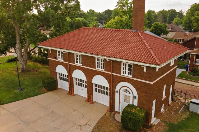 202 Poplar St, Harrisburg, IL 62946 - mediterranean / spanish house with a tiled roof, a chimney, and a garage