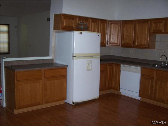 7617 Ivory Ave, Saint Louis, MO 63111 - kitchen featuring white appliances, a sink, and brown cabinetry