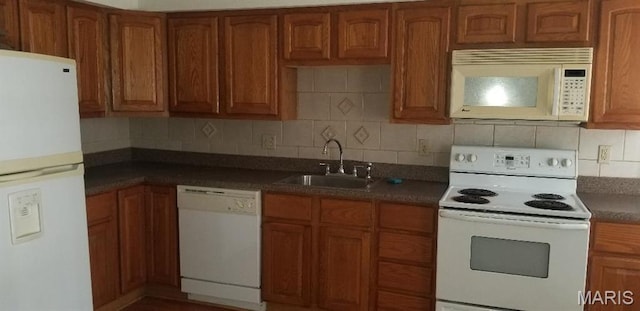 7617 Ivory Ave, Saint Louis, MO 63111 - kitchen with white appliances, a sink, and brown cabinetry